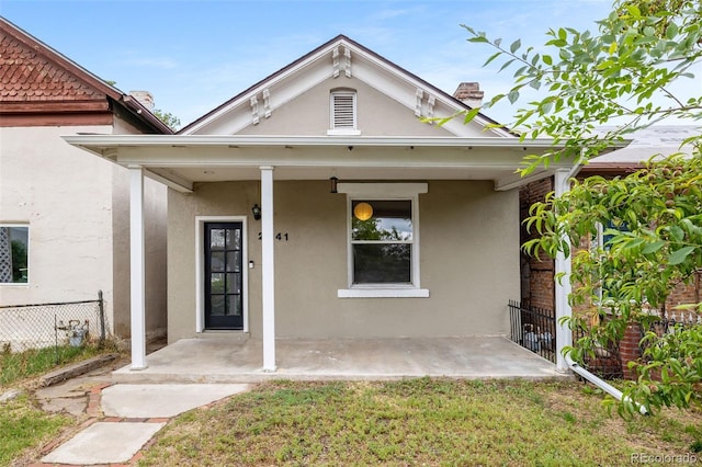2841 Stout St, Denver, CO 80205 - view of front of house featuring stucco siding and a chimney