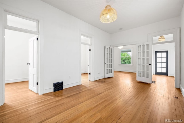 2841 Stout St, Denver, CO 80205 - unfurnished room featuring french doors, light wood-type flooring, and baseboards