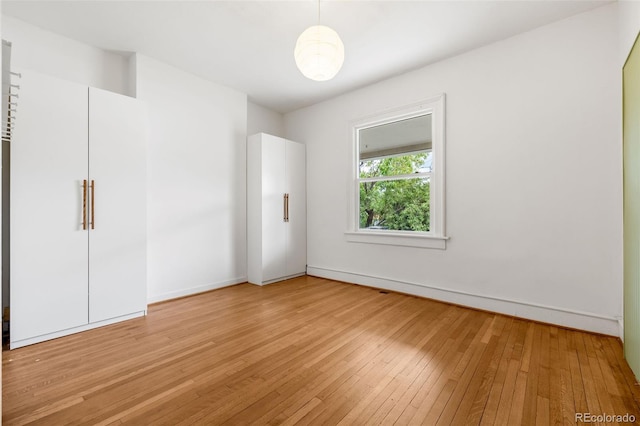 2841 Stout St, Denver, CO 80205 - unfurnished bedroom featuring light wood-style flooring and baseboards