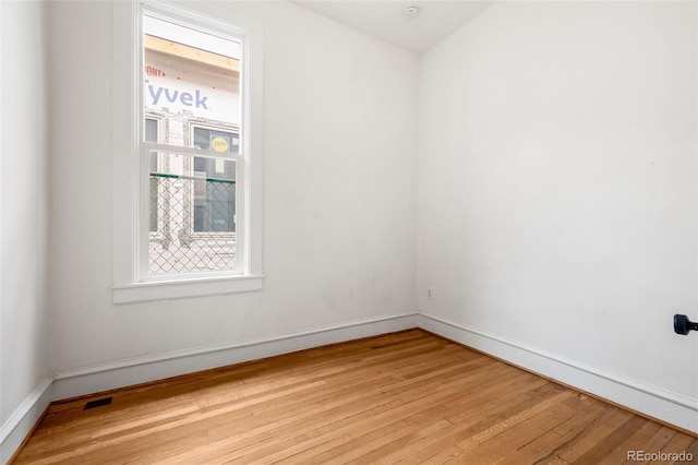 2841 Stout St, Denver, CO 80205 - unfurnished room featuring light wood finished floors, baseboards, and healthy amount of natural light
