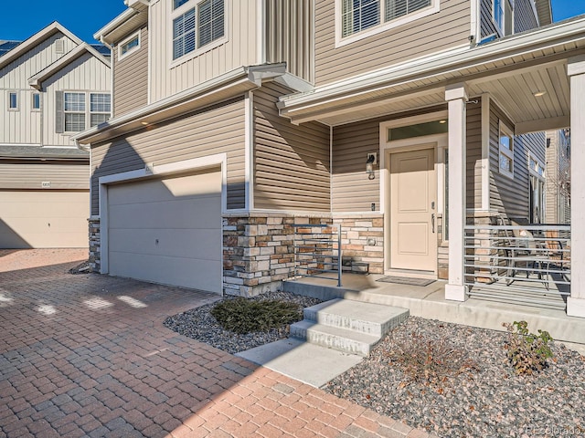 doorway to property featuring a garage and covered porch