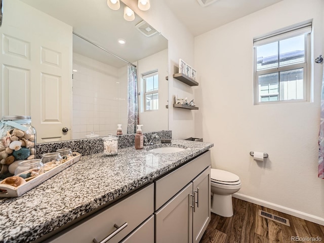 bathroom with vanity, toilet, a shower with shower curtain, and wood-type flooring