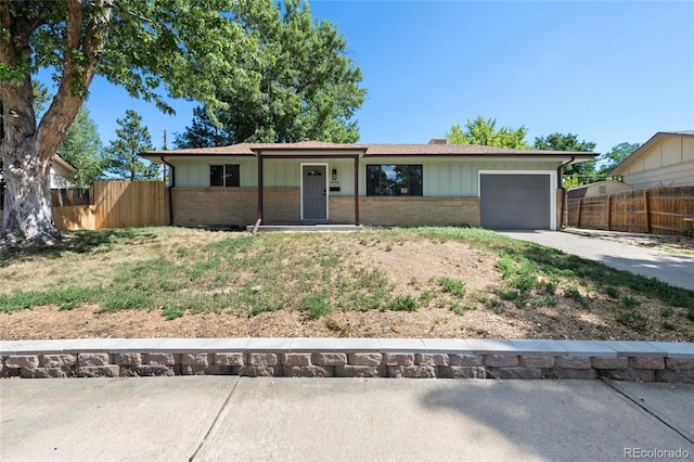 8580 Wiley Cir, Westminster, CO 80031 - ranch-style home featuring brick siding, concrete driveway, an attached garage, and board and batten siding