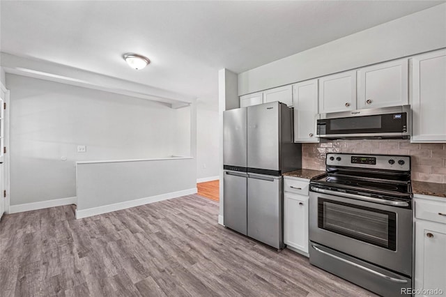 8580 Wiley Cir, Westminster, CO 80031 - kitchen featuring stainless steel appliances, decorative backsplash, white cabinets, and wood finished floors