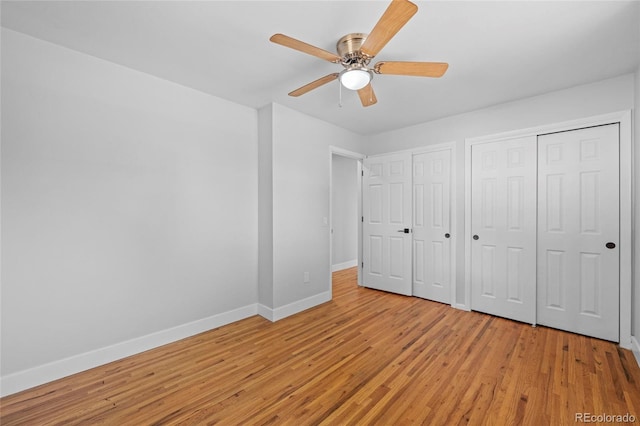 8580 Wiley Cir, Westminster, CO 80031 - unfurnished bedroom featuring light wood-style flooring, multiple closets, and a ceiling fan