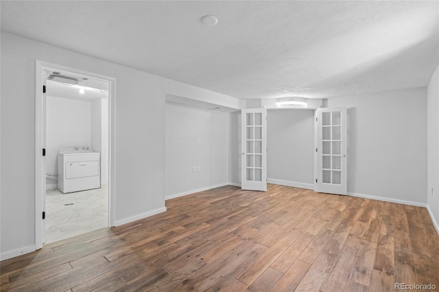 8580 Wiley Cir, Westminster, CO 80031 - spare room with washer / dryer, wood finished floors, french doors, and a textured ceiling