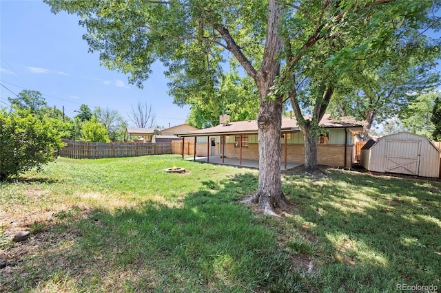 8580 Wiley Cir, Westminster, CO 80031 - fenced backyard with a storage shed, a fire pit, and a patio