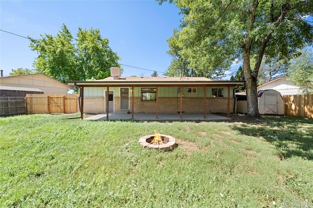8580 Wiley Cir, Westminster, CO 80031 - rear view of house featuring a patio, a fire pit, a storage shed, and a fenced backyard