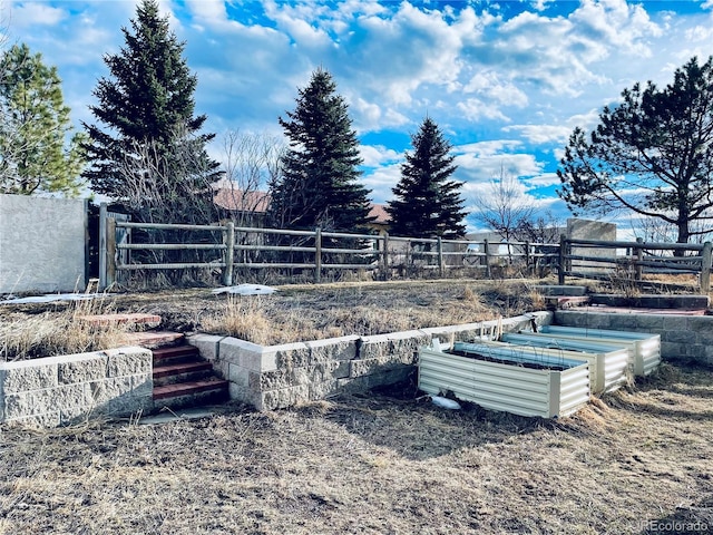 view of yard with a garden and fence