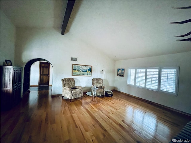 living area featuring arched walkways, high vaulted ceiling, visible vents, dark wood-style floors, and beamed ceiling