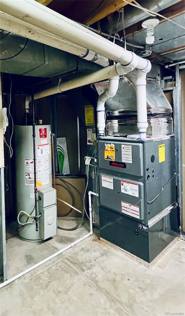 utility room featuring heating unit and water heater