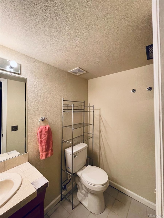 bathroom with a textured ceiling, tile patterned flooring, toilet, visible vents, and vanity