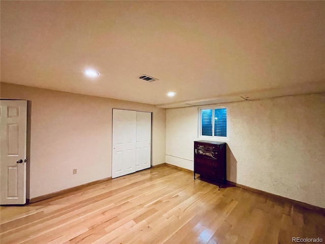 unfurnished bedroom with baseboards, visible vents, wood finished floors, and recessed lighting