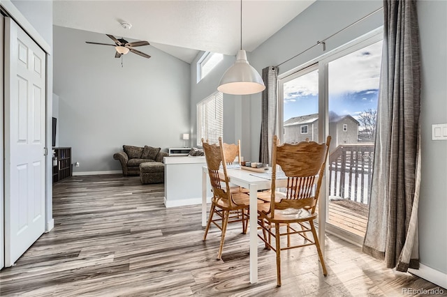 dining room featuring hardwood / wood-style flooring, ceiling fan, and lofted ceiling