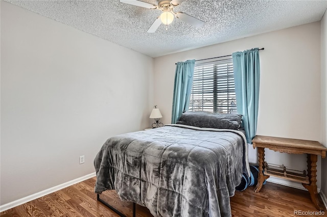 bedroom featuring a textured ceiling, dark hardwood / wood-style flooring, and ceiling fan