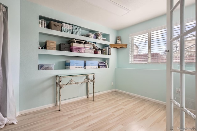 laundry area featuring hardwood / wood-style floors and built in features