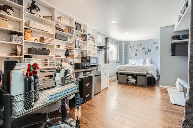 interior space with light hardwood / wood-style floors and a textured ceiling