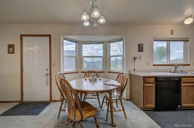 4987 Fabray Ln, Colorado Springs, CO 80922 - carpeted dining room with a sink, a chandelier, a textured ceiling, and baseboards