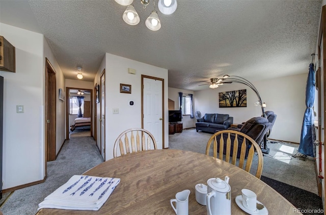 4987 Fabray Ln, Colorado Springs, CO 80922 - dining room with carpet, a chandelier, a textured ceiling, ceiling fan, and baseboards