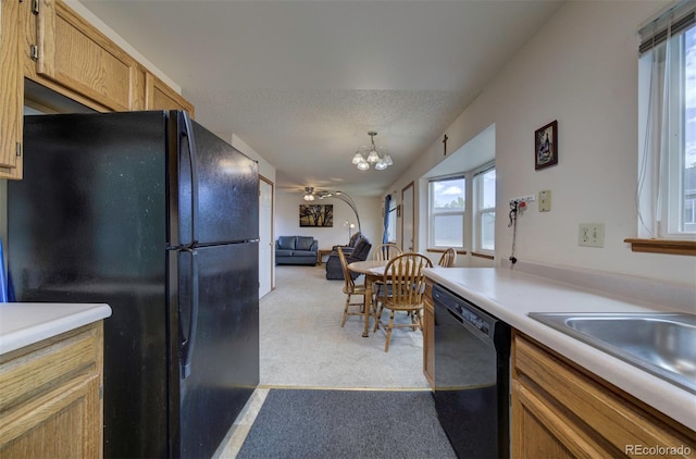 4987 Fabray Ln, Colorado Springs, CO 80922 - kitchen with black appliances, a chandelier, light countertops, and healthy amount of natural light
