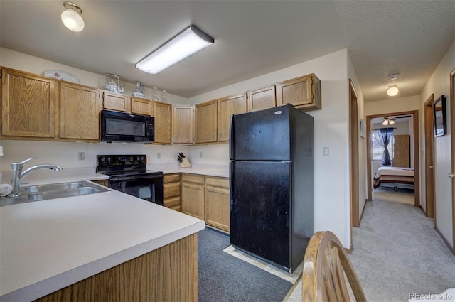 4987 Fabray Ln, Colorado Springs, CO 80922 - kitchen featuring black appliances, a sink, light colored carpet, and light countertops