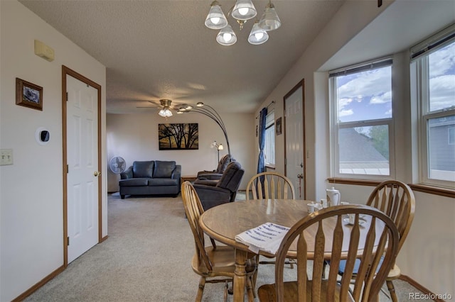 4987 Fabray Ln, Colorado Springs, CO 80922 - dining room featuring light colored carpet, a textured ceiling, baseboards, and a chandelier