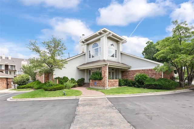 13873 E Lehigh Ave Unit B, Aurora, CO 80014 - view of front of house with brick siding and a front lawn