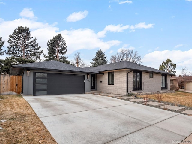 ranch-style house featuring a garage, concrete driveway, brick siding, and fence