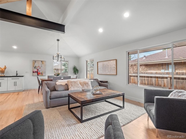 3049 S Vine St, Denver, CO 80210 - living area featuring a chandelier, light wood-type flooring, baseboards, healthy amount of natural light, and recessed lighting