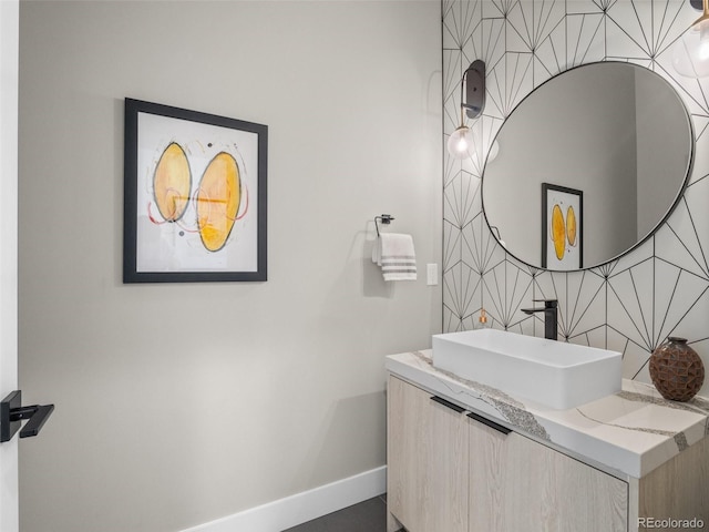 3049 S Vine St, Denver, CO 80210 - bathroom featuring vanity, baseboards, and tasteful backsplash