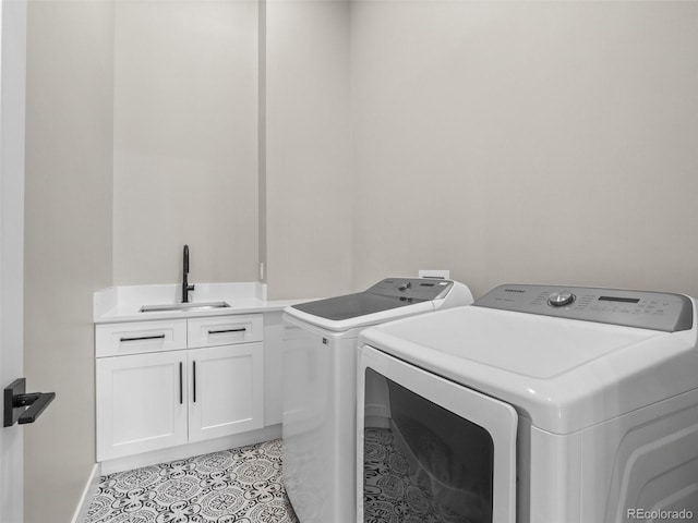 3049 S Vine St, Denver, CO 80210 - laundry area with washer and clothes dryer, cabinet space, light tile patterned floors, and baseboards