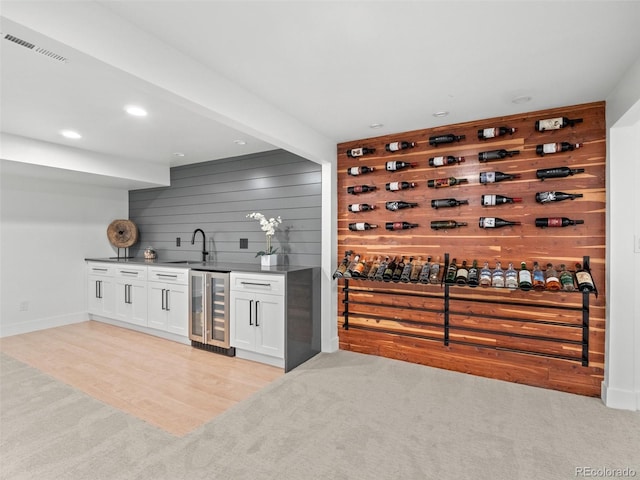 3049 S Vine St, Denver, CO 80210 - wine room with beverage cooler, bar with sink, light colored carpet, recessed lighting, and baseboards