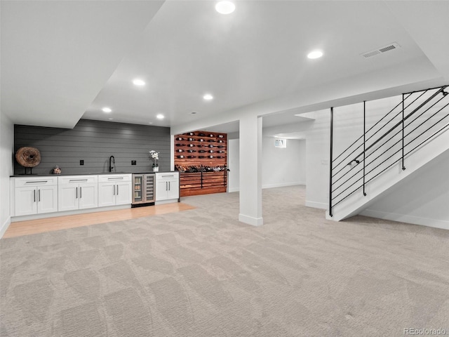 3049 S Vine St, Denver, CO 80210 - unfurnished living room featuring wet bar, wine cooler, baseboards, stairway, and light carpet