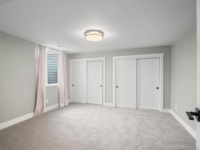 3049 S Vine St, Denver, CO 80210 - unfurnished bedroom with two closets, carpet, and baseboards