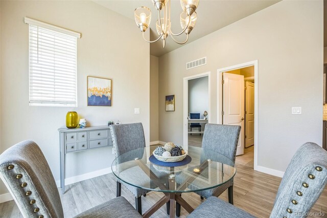 12574 Lake View St, Longmont, CO 80504 - dining space with a chandelier, light wood-type flooring, and baseboards