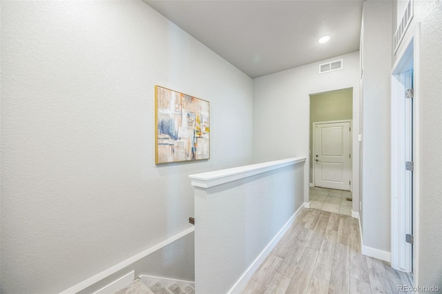 12574 Lake View St, Longmont, CO 80504 - hall with an upstairs landing, light wood finished floors, and baseboards