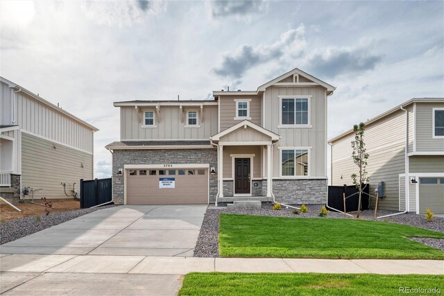2705 73rd Avenue Ct, Greeley, CO 80634 - craftsman inspired home with board and batten siding, an attached garage, driveway, and stone siding