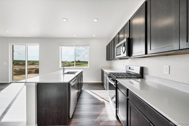 2705 73rd Avenue Ct, Greeley, CO 80634 - kitchen featuring appliances with stainless steel finishes, a sink, light countertops, dark wood-style flooring, and recessed lighting