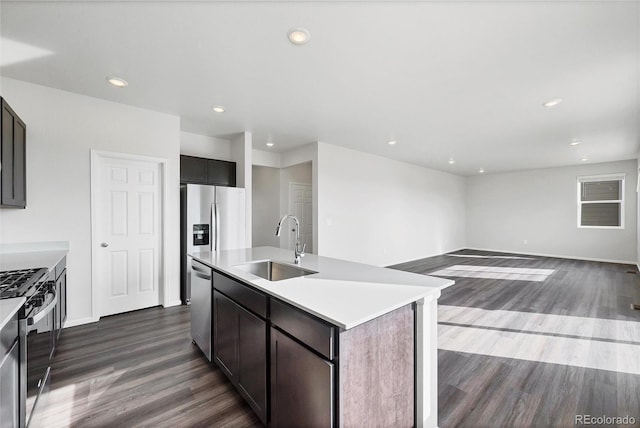 2705 73rd Avenue Ct, Greeley, CO 80634 - kitchen featuring a sink, appliances with stainless steel finishes, dark wood-style flooring, an island with sink, and recessed lighting