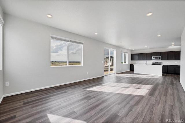 2705 73rd Avenue Ct, Greeley, CO 80634 - unfurnished living room with dark wood-style floors, recessed lighting, and baseboards