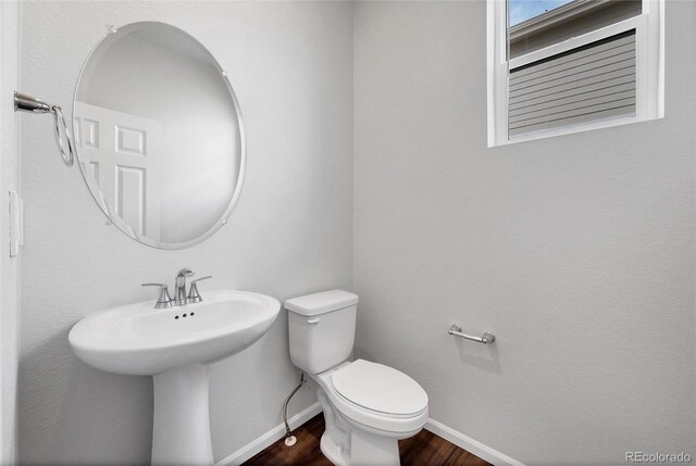 2705 73rd Avenue Ct, Greeley, CO 80634 - bathroom with wood finished floors, toilet, and baseboards