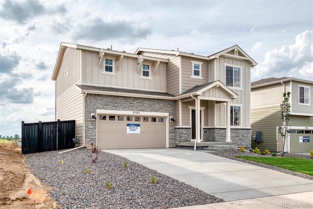 2705 73rd Avenue Ct, Greeley, CO 80634 - craftsman house featuring board and batten siding, an attached garage, driveway, and stone siding