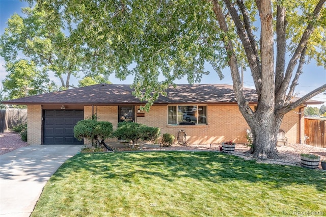 ranch-style home with a garage and a front lawn