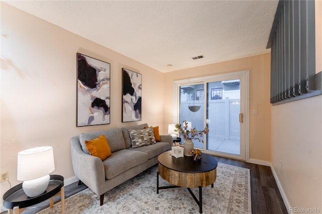 15491 E Wyoming Dr Unit A, Aurora, CO 80017 - living area with wood finished floors, baseboards, and a textured ceiling