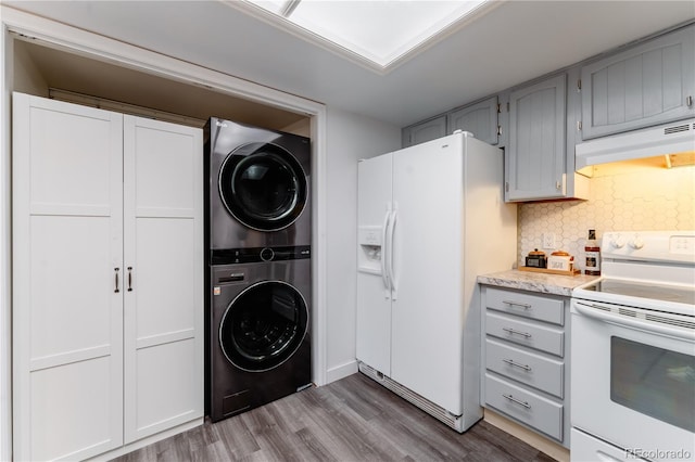15491 E Wyoming Dr Unit A, Aurora, CO 80017 - laundry room featuring stacked washer and clothes dryer and wood finished floors