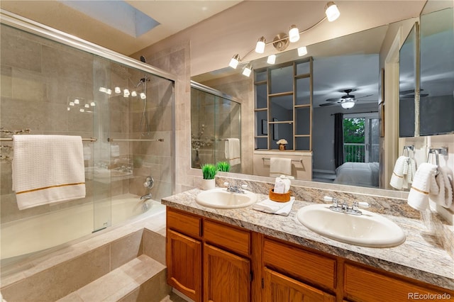 15491 E Wyoming Dr Unit A, Aurora, CO 80017 - ensuite bathroom featuring tiled tub, a tile shower, double vanity, and ceiling fan