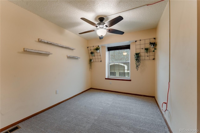 15491 E Wyoming Dr Unit A, Aurora, CO 80017 - empty room with carpet flooring, a ceiling fan, a textured ceiling, and baseboards