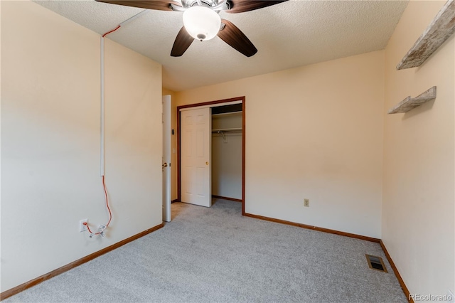 15491 E Wyoming Dr Unit A, Aurora, CO 80017 - unfurnished bedroom featuring light carpet, a textured ceiling, a closet, baseboards, and ceiling fan