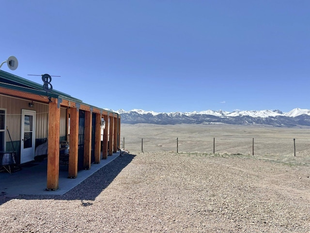 view of yard featuring a rural view and a mountain view