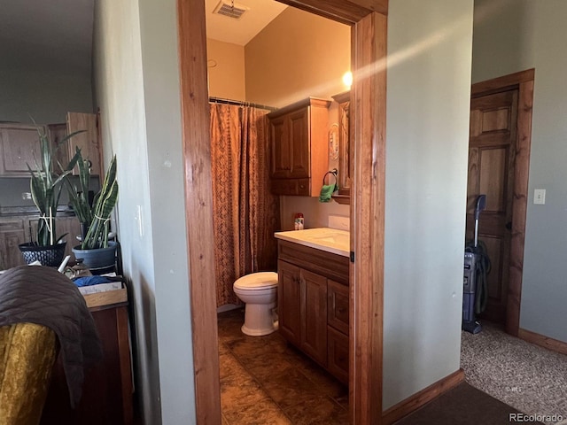 bathroom featuring toilet, tile floors, and vanity